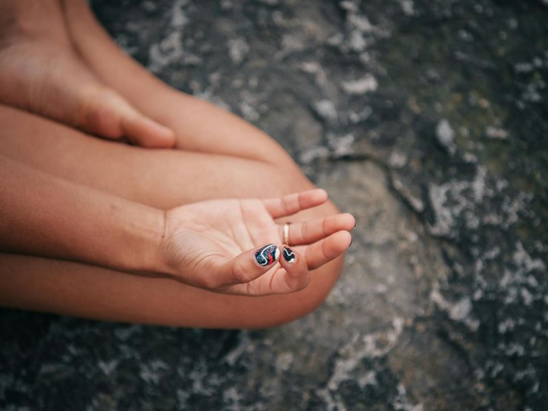 Close up of hands in a mudra position during yoga practice