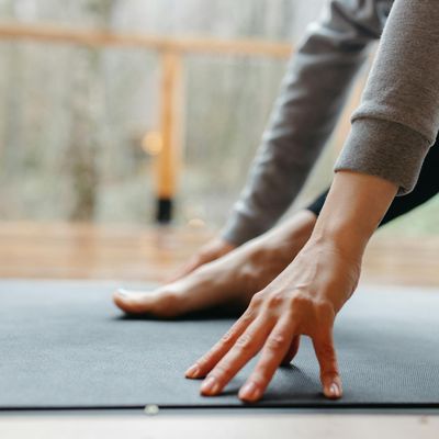Detail of a foot stretching on a yoga mat